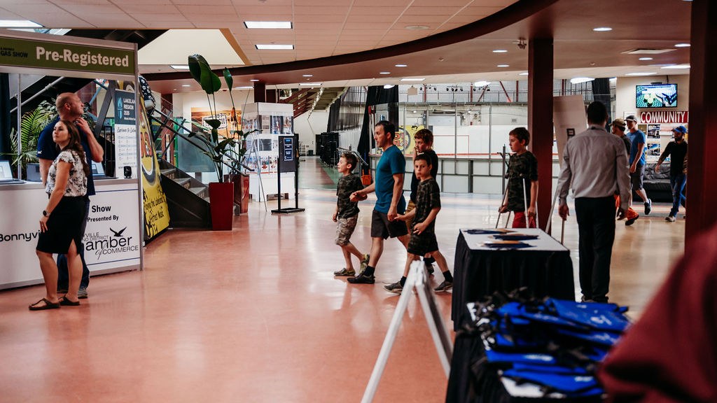 Attendees arriving at the BOAGS Oil and Gas Show, Chamber of Commerce welcome banner in the lobby